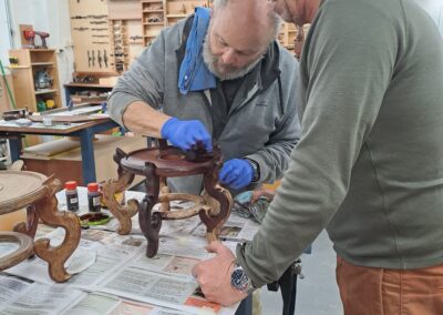 Furniture restoration tutor overseeing student and project