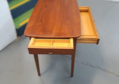 Small restored mid-century table with drawers open