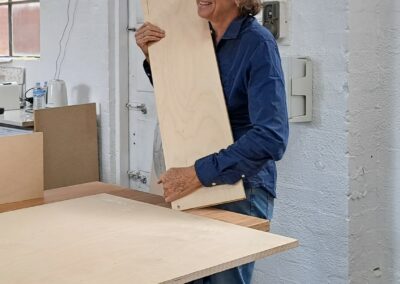 Student smiling and holding ply board